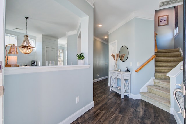 entrance foyer featuring ornamental molding, visible vents, baseboards, and wood finished floors