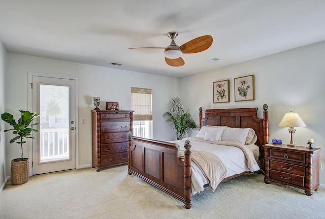 bedroom with access to outside, light colored carpet, visible vents, and multiple windows