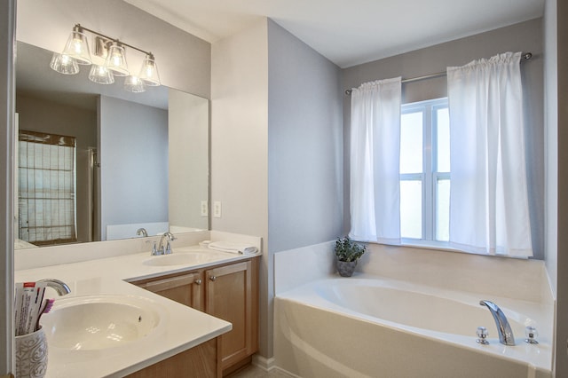 bathroom with a bath, double vanity, and a sink