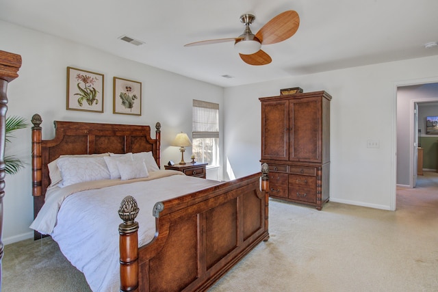 bedroom featuring a ceiling fan, light colored carpet, visible vents, and baseboards