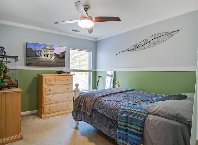 bedroom with light colored carpet, a ceiling fan, baseboards, visible vents, and ornamental molding