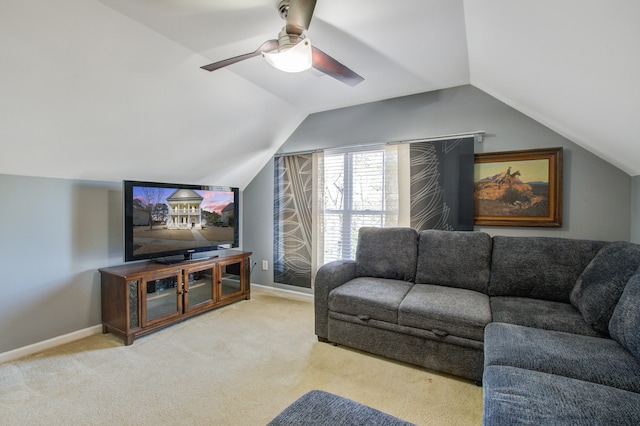 carpeted living area featuring lofted ceiling, baseboards, and a ceiling fan