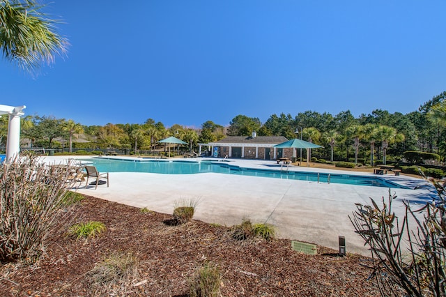 pool with fence and a patio