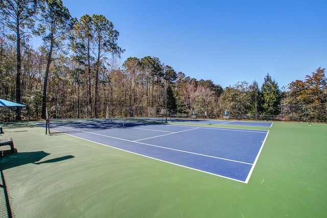 view of sport court featuring fence