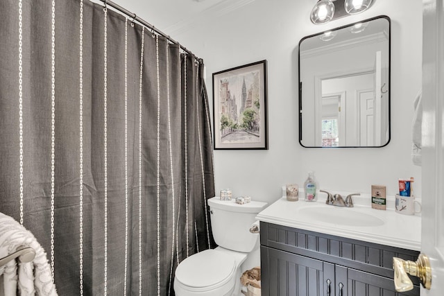 bathroom featuring toilet, ornamental molding, and vanity