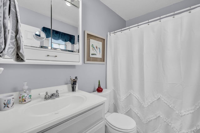 bathroom featuring a textured ceiling, toilet, vanity, and a shower with curtain