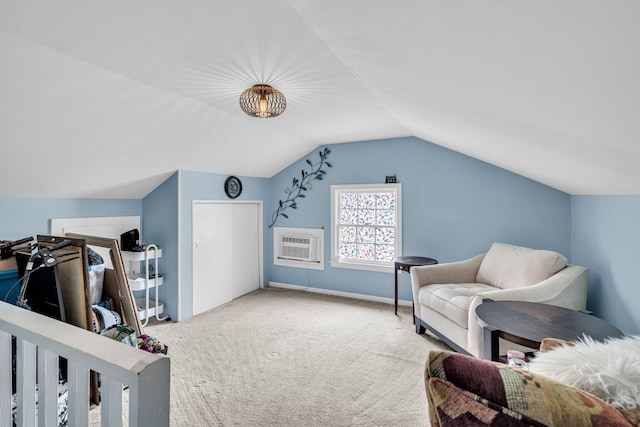 carpeted bedroom with baseboards, a wall unit AC, and vaulted ceiling