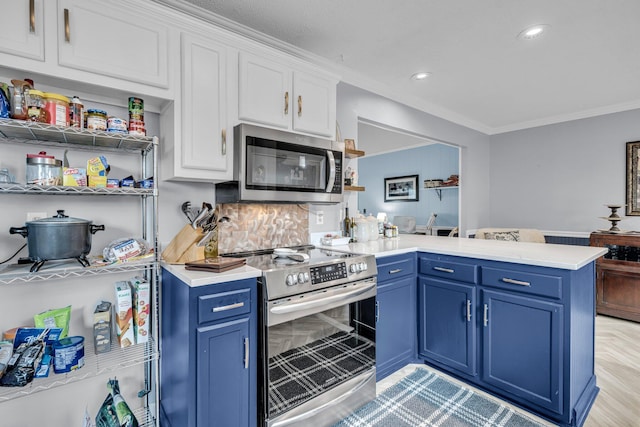 kitchen featuring a peninsula, white cabinets, blue cabinets, and stainless steel appliances