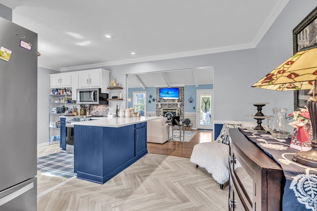 kitchen featuring blue cabinetry, ornamental molding, stainless steel appliances, light countertops, and white cabinets