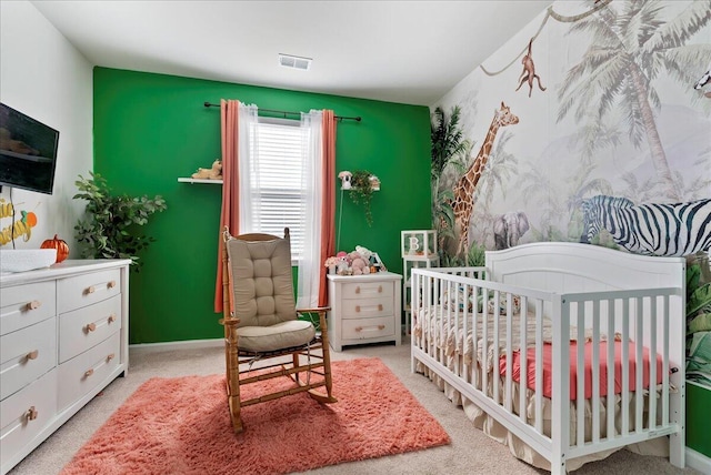 bedroom featuring light carpet and a crib