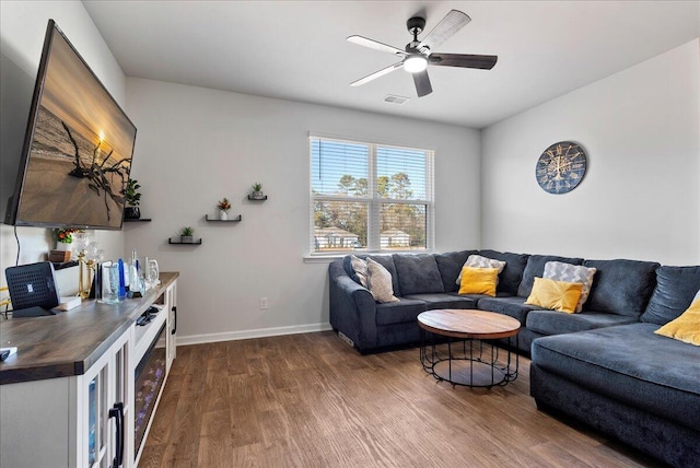 living room with ceiling fan and dark hardwood / wood-style flooring