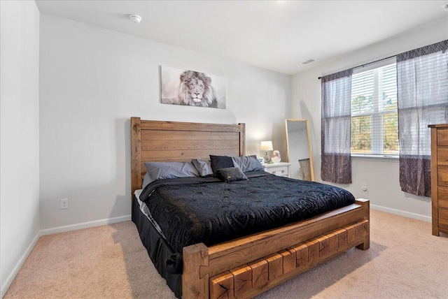 bedroom featuring light colored carpet