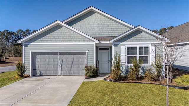 view of front of property featuring a front lawn and a garage