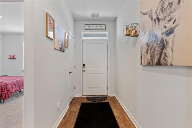 entryway with hardwood / wood-style floors