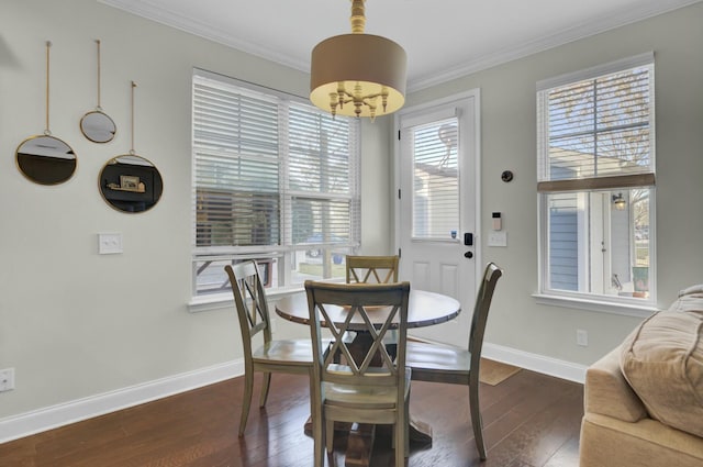 dining space with dark wood-style floors, baseboards, and ornamental molding