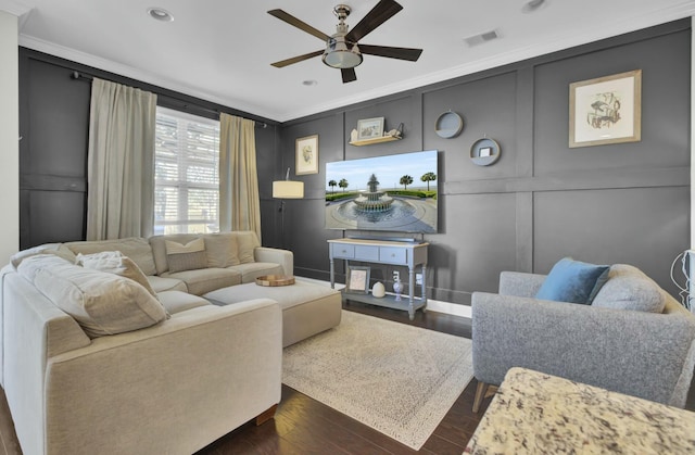 living room featuring visible vents, dark wood-style floors, ceiling fan, and a decorative wall