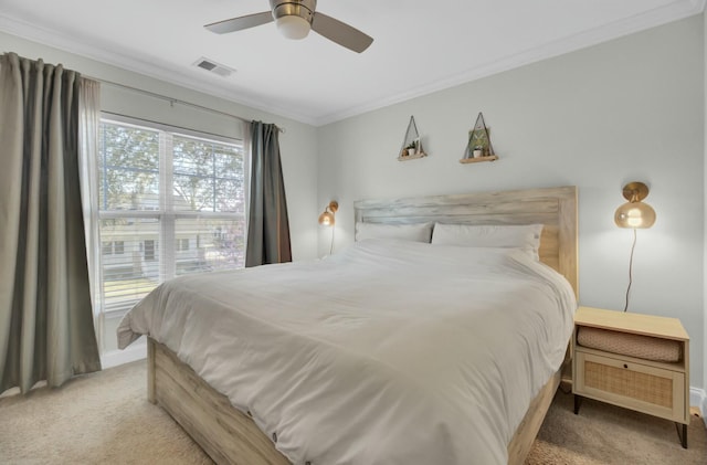 carpeted bedroom with crown molding, a ceiling fan, and visible vents