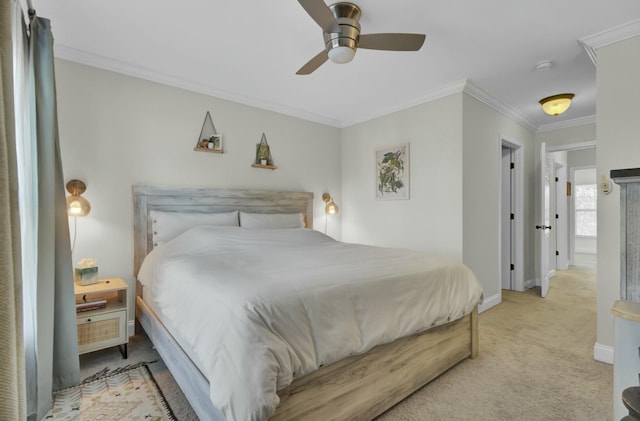 carpeted bedroom with ceiling fan, baseboards, and ornamental molding