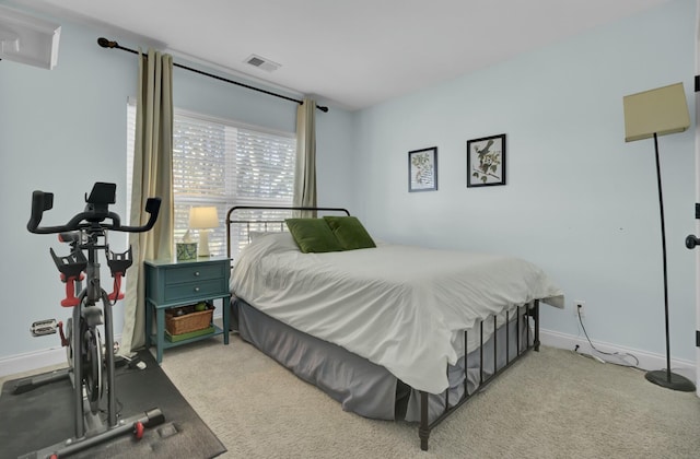 bedroom featuring light carpet, visible vents, and baseboards