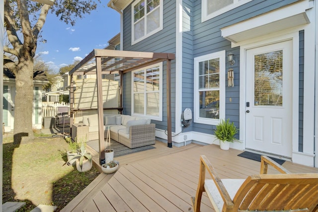 wooden terrace featuring an outdoor living space and a pergola