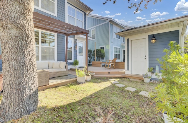 exterior space with a wooden deck, an outdoor hangout area, and a pergola