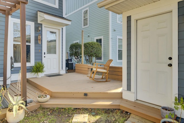 property entrance with covered porch and board and batten siding