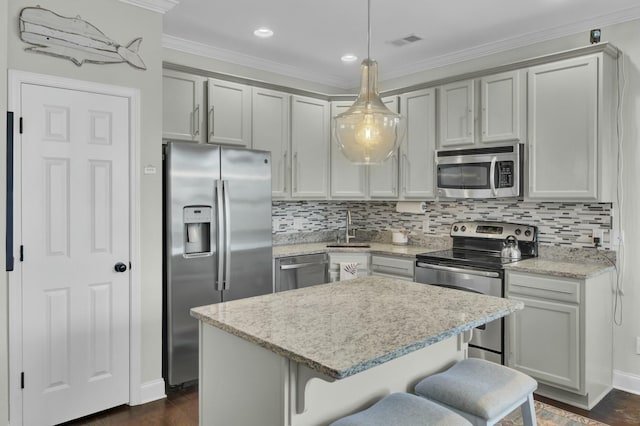 kitchen featuring a sink, decorative backsplash, appliances with stainless steel finishes, and ornamental molding