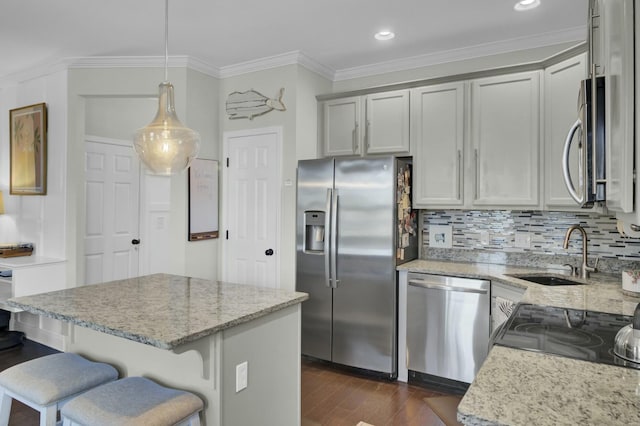 kitchen with a sink, backsplash, dark wood finished floors, stainless steel appliances, and crown molding