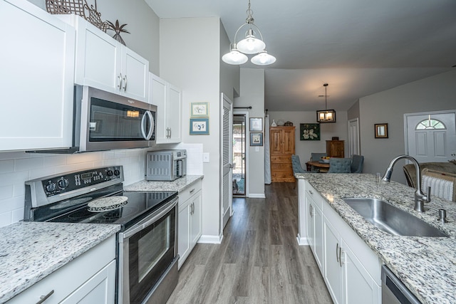 717 Temple Rd Unit B, Ladson, SC 29456 - kitchen with appliances with stainless steel finishes, a sink, light wood-style flooring, tasteful backsplash, and white cabinets