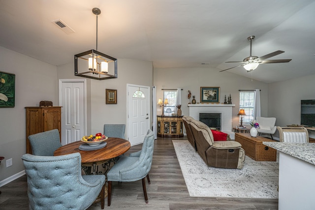 717 Temple Rd Unit B, Ladson, SC 29456 - dining area with lofted ceiling, a chandelier, ceiling fan, dark wood-style floors, and a brick fireplace