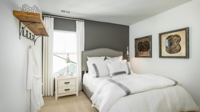 bedroom with light colored carpet