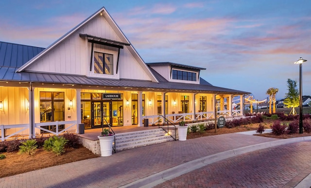 view of front of home featuring covered porch, a standing seam roof, metal roof, and board and batten siding