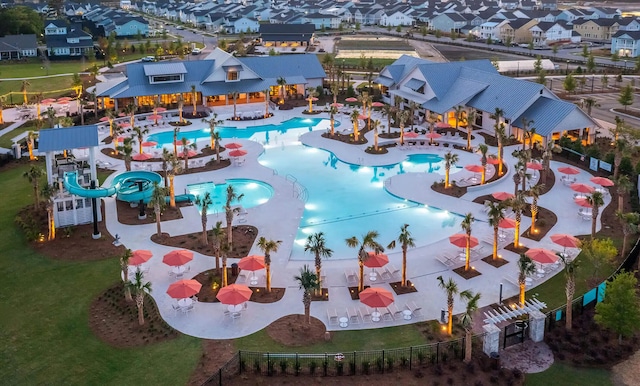 community pool featuring a fenced backyard and a patio
