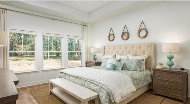 bedroom with wood finished floors and baseboards