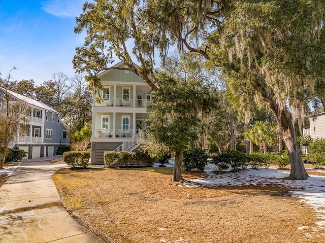 view of front of house with a balcony and covered porch