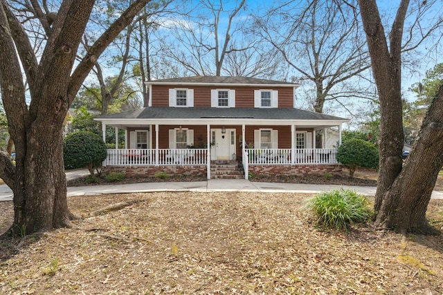 farmhouse with a porch and roof with shingles