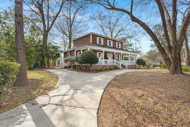 view of front of home with covered porch and concrete driveway