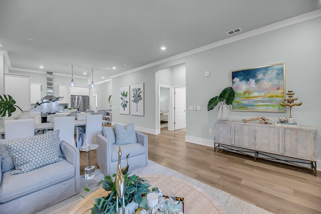 7416 Indigo Palms Way, Johns Island, SC 29455 - living area featuring light wood-type flooring, ornamental molding, recessed lighting, and baseboards