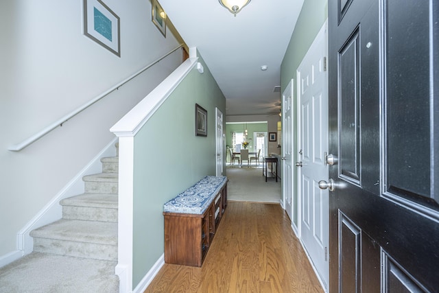 foyer entrance featuring ceiling fan and light hardwood / wood-style floors