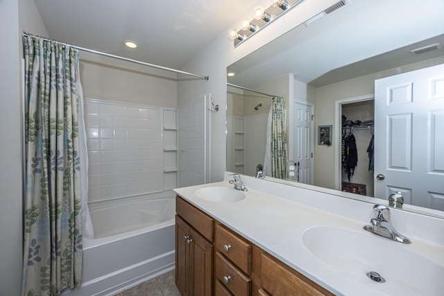 bathroom featuring tile patterned flooring, vanity, and shower / tub combo