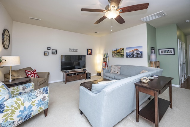 carpeted living room with ceiling fan