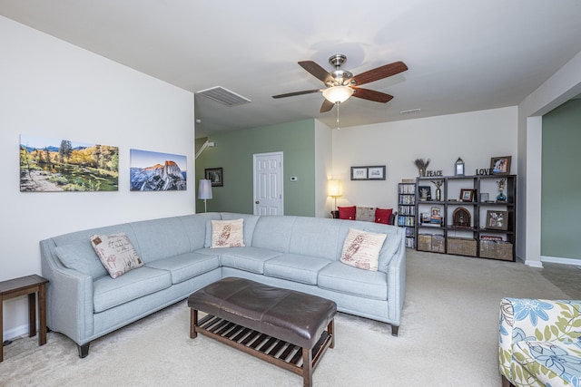 carpeted living room with ceiling fan