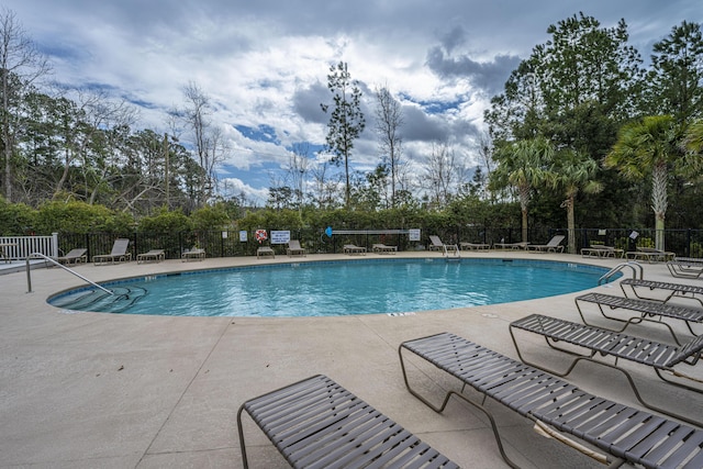 view of swimming pool with a patio