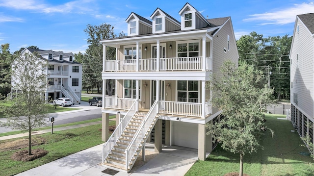 beach home featuring a porch, a garage, and a front lawn