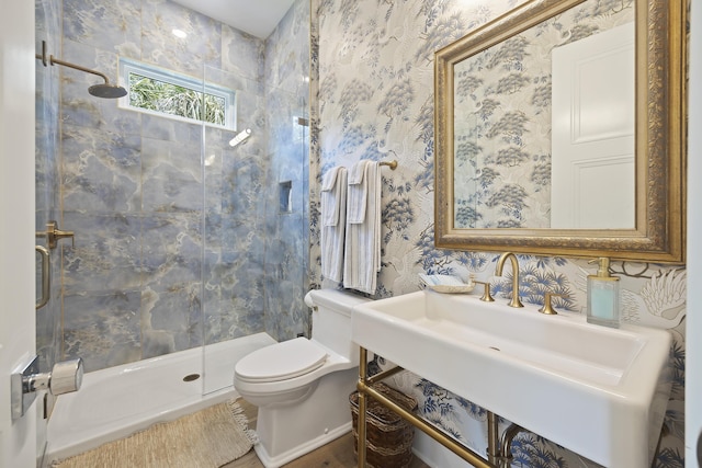 full bathroom featuring wallpapered walls, wood finished floors, toilet, and a shower stall
