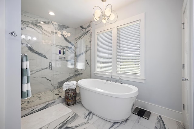 bathroom with marble finish floor, a marble finish shower, a freestanding bath, and a notable chandelier