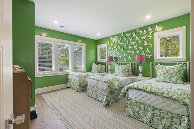 bedroom with recessed lighting, baseboards, visible vents, and wood finished floors