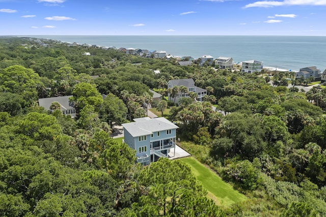 birds eye view of property featuring a water view and a wooded view