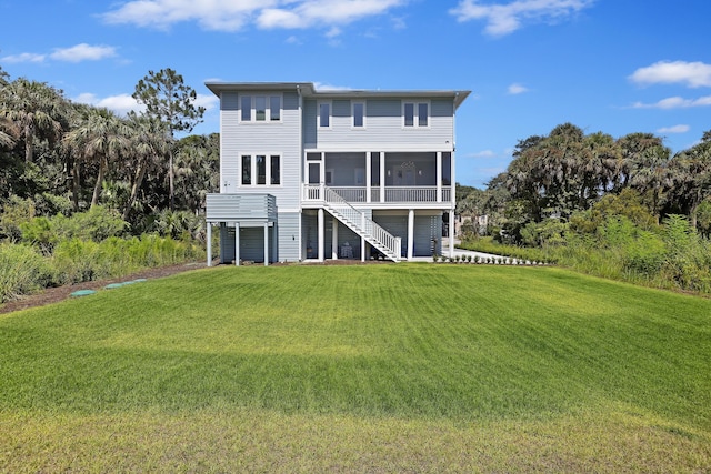 back of house with a sunroom, stairs, and a yard