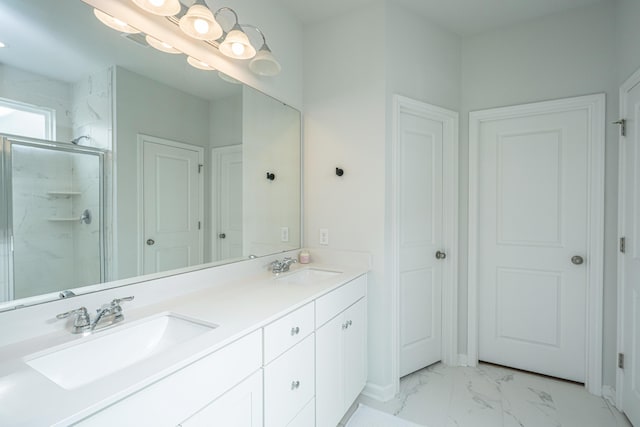 bathroom with marble finish floor, double vanity, a sink, and a marble finish shower